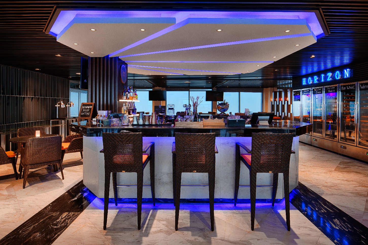 A bar with chairs and a blue light

AI-generated content may be incorrect.